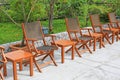 Row of wooden chairs set beside a pool Royalty Free Stock Photo