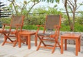 Row of wooden chairs set beside a pool Royalty Free Stock Photo