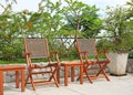 Row of wooden chairs set beside a pool Royalty Free Stock Photo