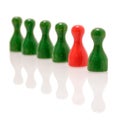 Row of wooden green figures and one red figure. Teamwork, balance and divercity concept