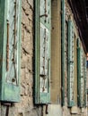 Row of wooden jalousie windows on a brick wall