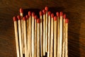 Row or Wooden Matches with Red Heads on Wooden Background