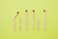 Row wooden matches yellow background,broken whole matches. Distinctive feature,broken personality,psychology concept