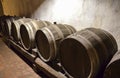 Row of wooden oak wine barrels in winery cellar Royalty Free Stock Photo