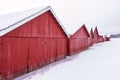 Row of wooden red boathouses in winter Royalty Free Stock Photo