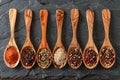 A row of wooden spoons with various spices on them Royalty Free Stock Photo