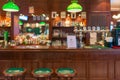 Row of wooden stools in front of green counter at the bar and pub, restuarant for drinking refresh relaxation in day life retro Royalty Free Stock Photo