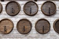 A row of wooden wine barrels built into a wooden wall