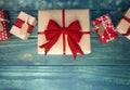 A Row of Wrapped Christmas Presents on Blue Wood Table