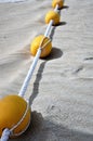 Yellow buoys on a sandy beach. Royalty Free Stock Photo