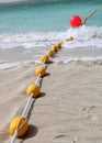 Yellow buoys on the sandy beach and in the water. Royalty Free Stock Photo