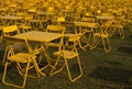 Row of yellow metal chairs and tables in plenty Royalty Free Stock Photo