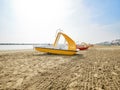 Row of yellow pedal boats with waterslide and lifeboats Royalty Free Stock Photo