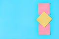 Row of yellow and red square blank paper stickers on blue background. Copy space Royalty Free Stock Photo