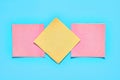 Row of yellow and red square blank paper stickers on blue background. Copy space Royalty Free Stock Photo