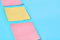 Row of yellow and red square blank paper stickers on blue background Royalty Free Stock Photo