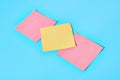 Row of yellow and red square blank paper stickers on blue Royalty Free Stock Photo