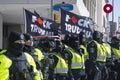 A row of York Regional Police officers stand in front of F*ck Trudeau flags at the Freedom Convoy in Ottawa