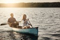 Row your boat and find happiness. a young couple rowing a boat out on the lake.