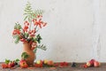 the rowan berry and appples in jug on old wooden table Royalty Free Stock Photo