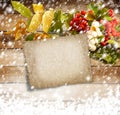 Rowan branch on the snow-covered wooden background