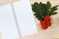 Rowan ripe and blank notepad on white wooden table