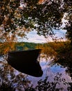 Rowboat reflected in the forest lake Royalty Free Stock Photo