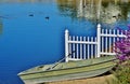 A rowboat on the shore of a lake.