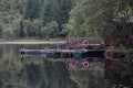 Rowboats tied to a dock by a the deck of a cabin Royalty Free Stock Photo