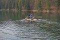 Rower on a raft in the middle of Lake Synevir. Carpathian mountains. Ukraine.