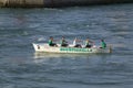 Rowers in green shirts rowing in Genoa Harbor, Genoa, Italy, Europe