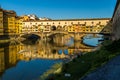 Rowers out on the River Arno during a lovely sunny morning in Florence, Italy, with the historic Ponte Vecchio in the background