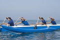 Rowers Paddling Outrigger Canoe In Race