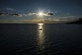 Rowing boat caught in the beam of light of a lowering sun. Southend on Sea, Essex