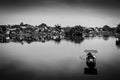 Rowing boat on a lake in Hoi An ancient town with traditional houses in the background. Black and white. Hoian, Vietnam. Hoi An,