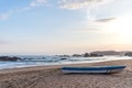 Rowing boat on a lonely sandy beach at the Pacific Ocean during the sunset Royalty Free Stock Photo