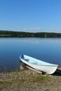 Rowing boat moored on calm lake shore Royalty Free Stock Photo