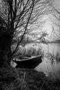 Rowing boat is moored on the shore of a frozen lake Royalty Free Stock Photo