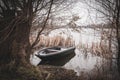 Rowing boat is moored on the shore of a frozen lake Royalty Free Stock Photo