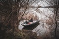 Rowing boat is moored on the shore of a frozen lake Royalty Free Stock Photo