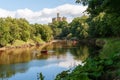 Rowing boats on the River Coquet with Warkworth Castle in the background