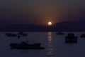 Rowing boats and speedboats in silhouettes. Royalty Free Stock Photo