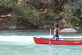 Rowing down the river in red boat Royalty Free Stock Photo