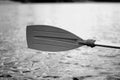 Rowing, holding a kayak paddle in black and white colors