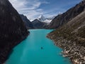 Rowing paddle boat on blue turquoise alpine mountain lake Laguna Paron in Caraz Huaraz Ancash Cordillera Blanca Peru Royalty Free Stock Photo