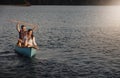 Rowing success. a young couple rowing a boat out on the lake. Royalty Free Stock Photo