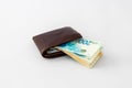 Ãârown leather wallet and stack of banknotes new Israeli shekels on white background Royalty Free Stock Photo