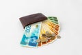 Ãârown leather wallet and stack of banknotes and several coins of new Israeli shekels on white background Royalty Free Stock Photo