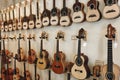 Rows of acoustic guitars on the wall