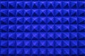 Rows of acoustic music soundproof foam pyramid panel with blue lighting